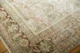 Distressed vintage Mahal rug corner, showing hard wear with exposed foundation and muted floral design.