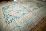 Distressed vintage Khorassan carpet corner with faded apricot, pale blue, and teal palmettes.