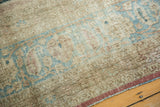 Distressed vintage Khorassan rug close-up showing visible foundation and muted beige-blue patterns.