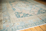 Vintage Distressed Persian Khorassan rug featuring faded palmettes in soft blue, apricot, and beige.
