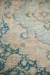 Distressed Khorassan carpet corner showing faded apricot, powder blue boteh, and soft palmettes.