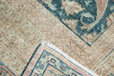 Distressed Khorassan rug corner, soft worn pile, faint foundation, pale blue and apricot motifs.