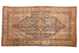 Antique Fereghan carpet with diamond medallion, allover Herati motif, navy and madder red tones.