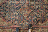 Antique Fereghan carpet's diamond medallion, Herati motif, and rich palette with lovely patina.
