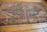 Antique Fereghan carpet corner detailing Herati motif, navy, blush, oxidized green, and visible wear.