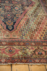 Antique Fereghan carpet's corner spandrel with madder root red, navy, and pale green floral patterns.