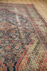 Antique Fereghan carpet corner showing diagonal floral spandrel, Herati pattern, with time-softened pile.