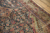 Antique Fereghan carpet corner: diagonal floral pattern, Herati field, navy, blush, pale green.
