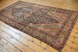 Antique Fereghan carpet corner with blush and pale green floral spandrel, madder red border, fringe.