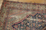 Antique Fereghan carpet corner with Herati field, blush and green spandrel, and visible foundation.