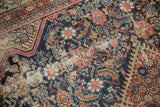 Antique Fereghan carpet detail featuring Herati motif, spandrel, low pile, and visible foundation.
