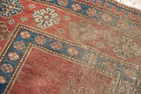 Late 19th century Caucasian carpet's madder red field, indigo border, and etched pile texture.
