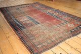 Antique Caucasian carpet corner: madder root red field, indigo blue border, pawn motif.