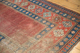 Madder red field patina and indigo blue pawn motif border of an antique Caucasian rug.