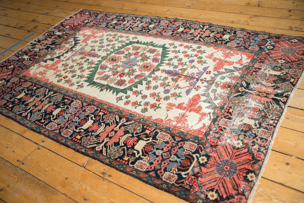 High-angle view of an antique Farahan Sarouk rug, highlighting its detailed borders and central medallion.