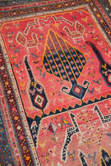 Karabagh runner detail: navy germinating tree motif on fuchsia, surrounded by bird and animal designs.