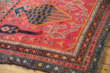 Hand-knotted Armenian Karabagh rug, showing layered geometric borders and fuchsia field.