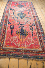 Antique Karabagh runner's fringe and lower section, with fuchsia field and stylized animal motifs.