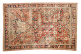 Distressed vintage Mahal rug, brick red and navy with splayed medallion motifs.
