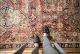 Distressed Vintage Mahal rug in brick red, navy, and beige with allover worn pattern.