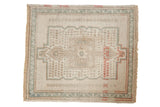 Distressed Oushak rug mat with faded ivory medallion, soft seafoam green, and terra cotta accents.