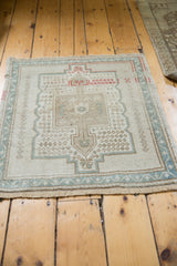 Distressed vintage Oushak rug pile, with even wear and muted ivory, seafoam tones.