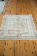 Distressed Oushak rug corner, ivory fringe, original selvages, and even pile wear.