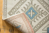 Hand-knotted vintage Oushak rug reverse, revealing tight foundation, original pale rose selvedge, and geometric pile.