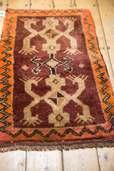 Vintage Oushak rug with plum and tangerine triple crab design and thick pile.