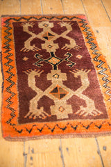 Vintage Oushak rug with prominent plum and tangerine orange crab design.