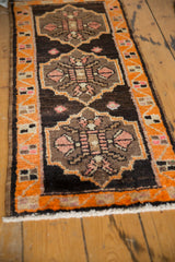 Fringe and tangerine orange geometric border of a vintage Oushak rug.