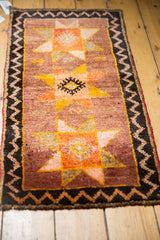 Thick pile of vintage Turkish Oushak rug, charcoal zig-zag border, saffron-orange starburst.