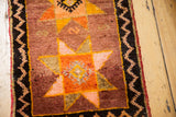 Oushak rug showing oversized tangerine, saffron, blush starburst and charcoal zig-zag border.