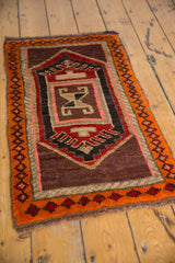Hand-knotted Oushak rug corner detail, highlighting tangerine geometric border and red, blush motifs.