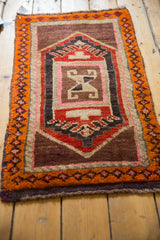 Thick pile of a vintage Oushak rug mat, with tangerine orange geometric border and central design.