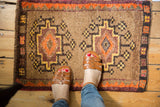 Thick pile vintage Oushak mat, tangerine, plum, saffron geometric medallions.