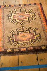 Detail of vintage Turkish Oushak rug with geometric medallion, thick pile, and camel, orange, plum hues.