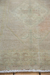 Distressed vintage Oushak rug with evenly worn ivory, sand pile and fringe.