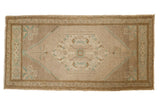 Vintage distressed Oushak rug mat with central diamond, muted ivory, beige, and mint green.