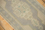 Distressed Oushak runner with muted geometric patterns and soft, even pile wear.