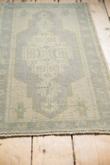 Distressed vintage Oushak rug texture revealing visible knot heads and dark warp threads.