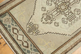 Oushak rug corner with stepped perimeter, geometric border, and even wear.