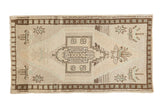 Vintage Distressed Oushak rug, geometric medallion with serrated outlines, nuanced ivory, beige, brown, abrashes.
