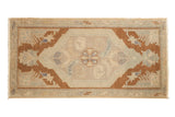 Vintage distressed Oushak rug mat with an unusual bronze field, oversized medallion, and expressive leaves.