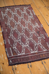 Hand woven Jijim rug panel design with ivory floral guls and dark red tones.