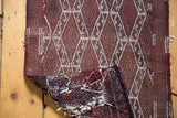 Vintage Jijim rug corner, showing hand-woven reverse texture with multicolored yarn strands.