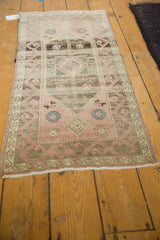 Distressed Oushak runner, blush rose and chocolate brown, showing faded medallion and vine motif.