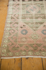 Distressed vintage Oushak rug's blush rose and silver patterns with softened pile and fringe.