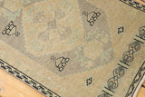 Distressed Oushak rug pile with even wear; subtle ivory, seafoam, and charcoal patterns.