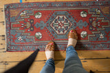 Vintage Oushak rug with brick red field, slate gray blue medallion, and floral patterns.